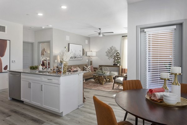 Spacious living room with modern decor at Alta Surprise Apartments, featuring cozy seating and natural light