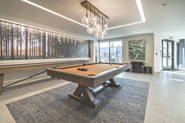 Clubroom featuring modern furnishings and communal seating at Alta University Place Apartments