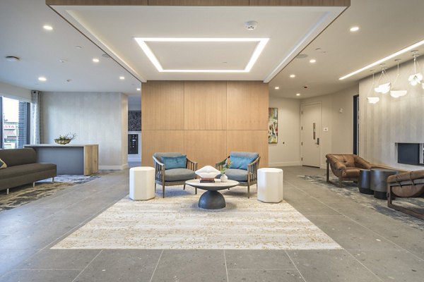 Clubroom featuring modern seating and large screen TV at Alta University Place Apartments