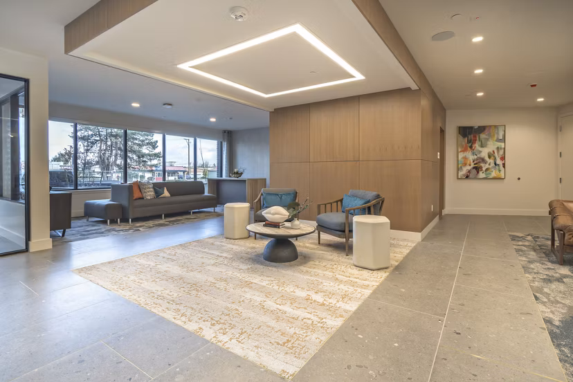 Clubroom featuring modern seating and communal tables at Alta University Place Apartments