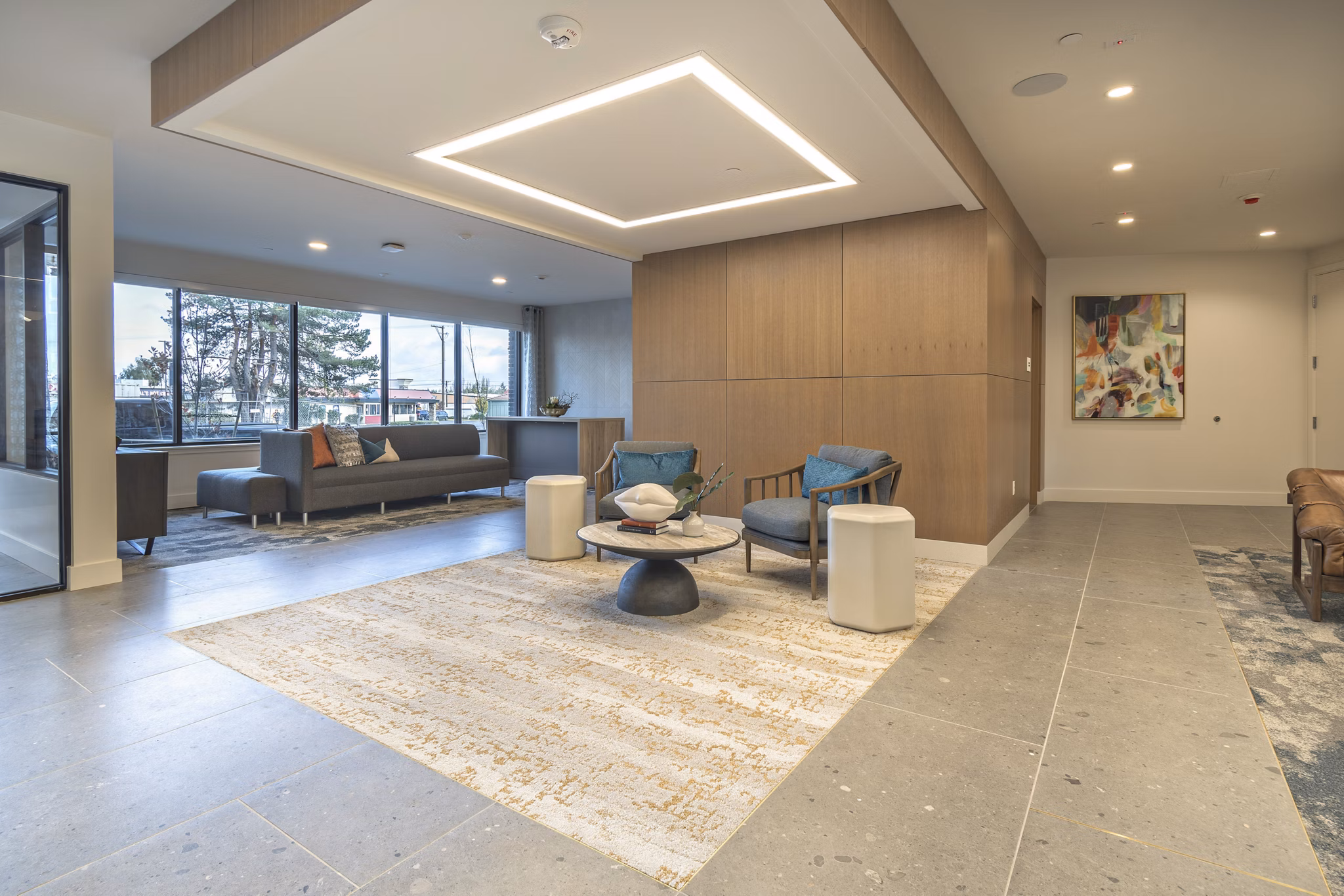 Clubroom featuring modern seating and communal tables at Alta University Place Apartments