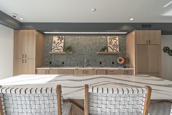 Clubroom with modern dÃ©cor and seating in Alta University Place Apartments