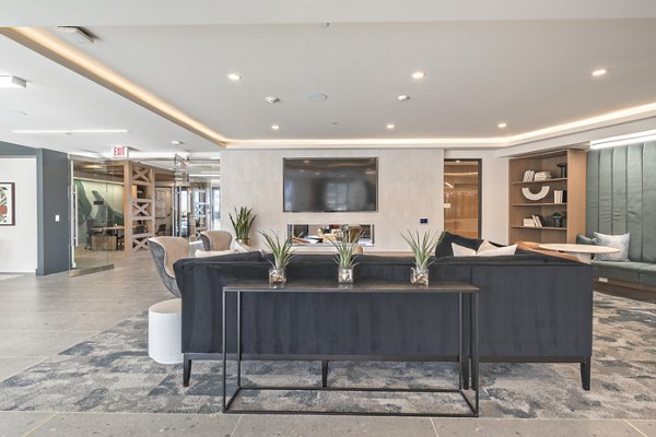 Clubroom featuring cozy seating and modern decor at Alta University Place Apartments, ideal for luxury living and socializing