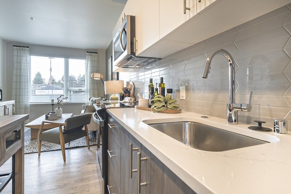 Modern kitchen featuring stainless steel appliances at Alta University Place Apartments