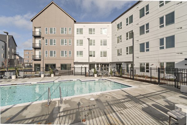 Upscale pool with lounge seating at Alta University Place Apartments