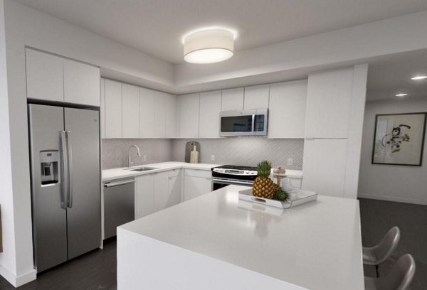 Modern kitchen with stainless steel appliances in Alta Waverly Apartments