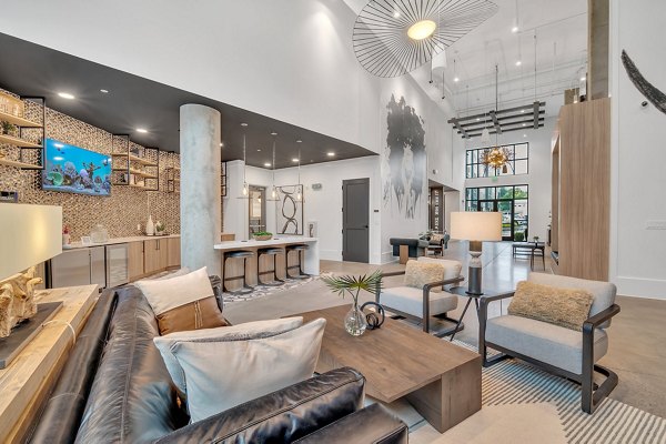 Clubhouse featuring modern seating and entertainment areas at Alta West Morehead Apartments in a luxury residential community