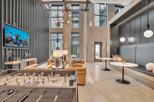 Modern club house room featuring sleek furniture and open layout at Alta West Morehead Apartments