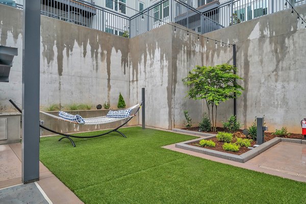 Chic outdoor patio space with modern furniture at Alta West Morehead Apartments