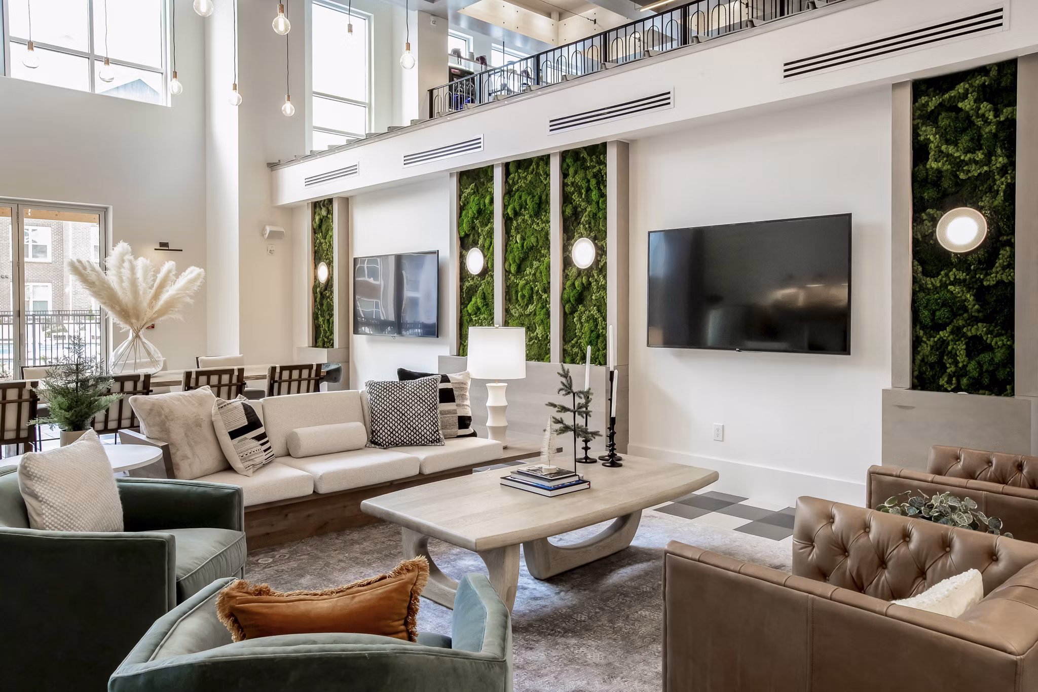 Clubhouse lounge with modern dÃ©cor at Alta Wren Apartments, featuring comfortable seating and large windows