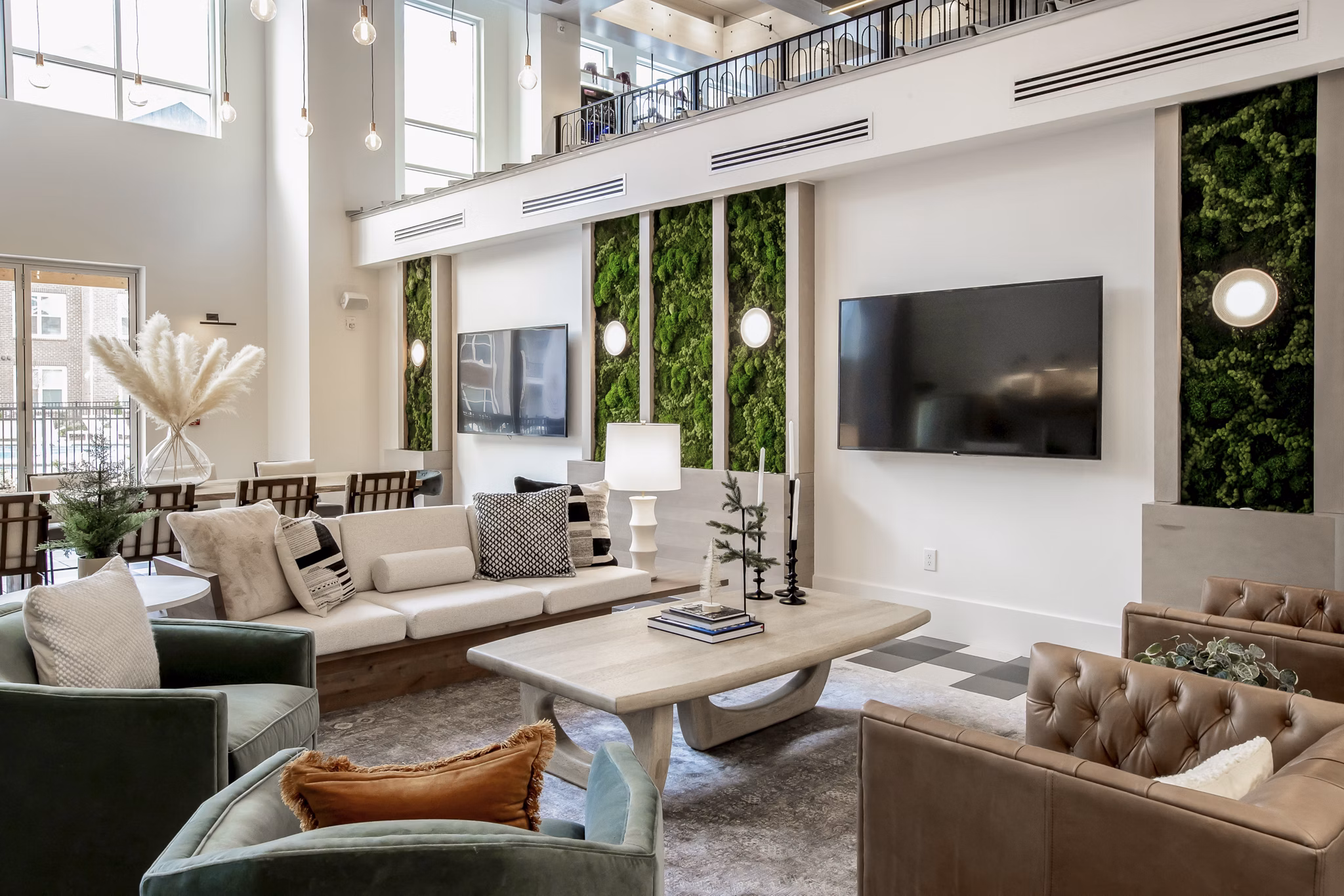 Clubhouse lounge with modern dÃ©cor at Alta Wren Apartments, featuring comfortable seating and large windows