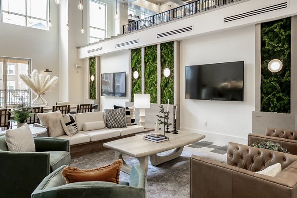 Clubhouse lounge with modern dÃ©cor at Alta Wren Apartments, featuring comfortable seating and large windows