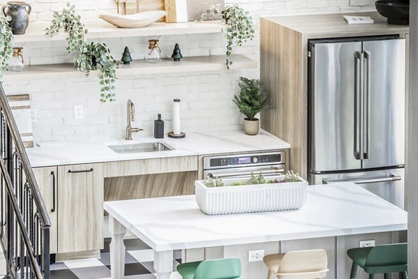 Modern dining area with elegant furnishings at Alta Wren Apartments, featuring ample natural light and stylish design elements