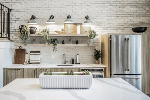 Modern kitchen with stainless steel appliances in Alta Wren Apartments