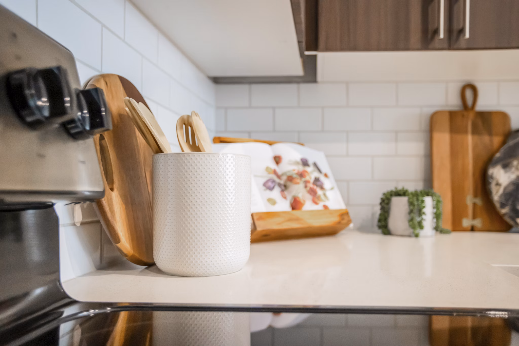 Alta Wren Apartments: Modern kitchen with stainless steel appliances and granite countertops