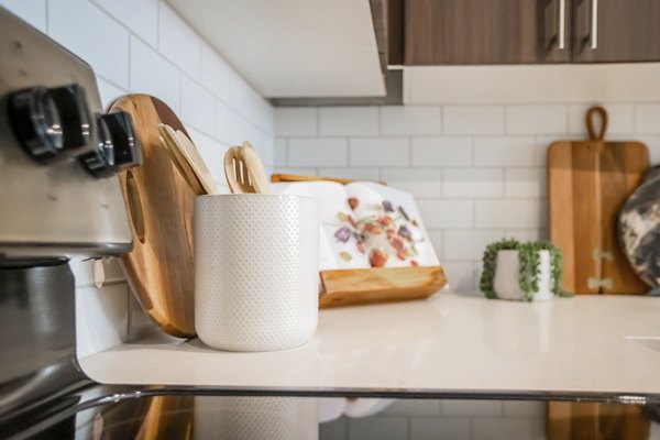 Alta Wren Apartments: Modern kitchen with stainless steel appliances and granite countertops