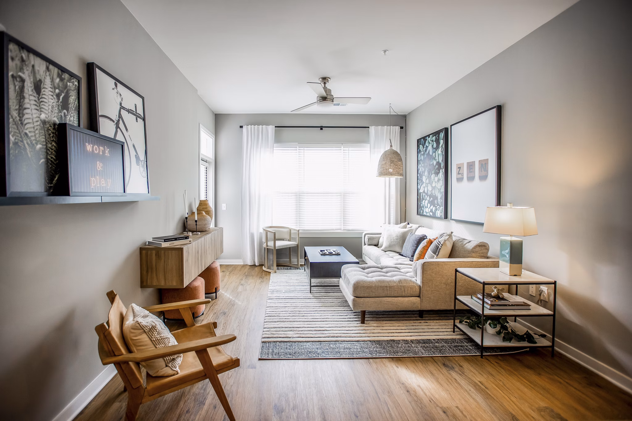 Living room with modern furnishings and ample natural light at Alta Wren Apartments