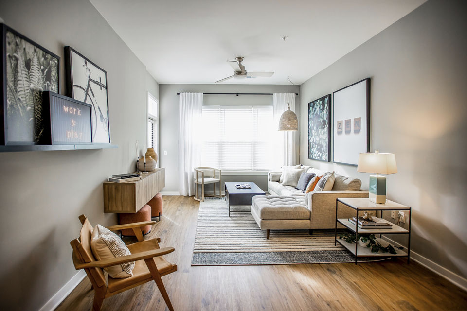 Living room with modern furnishings and ample natural light at Alta Wren Apartments