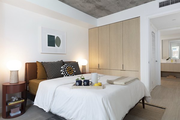 Bedroom featuring contemporary design and plush bedding at The Brady Apartments, luxury living by Greystar in urban setting