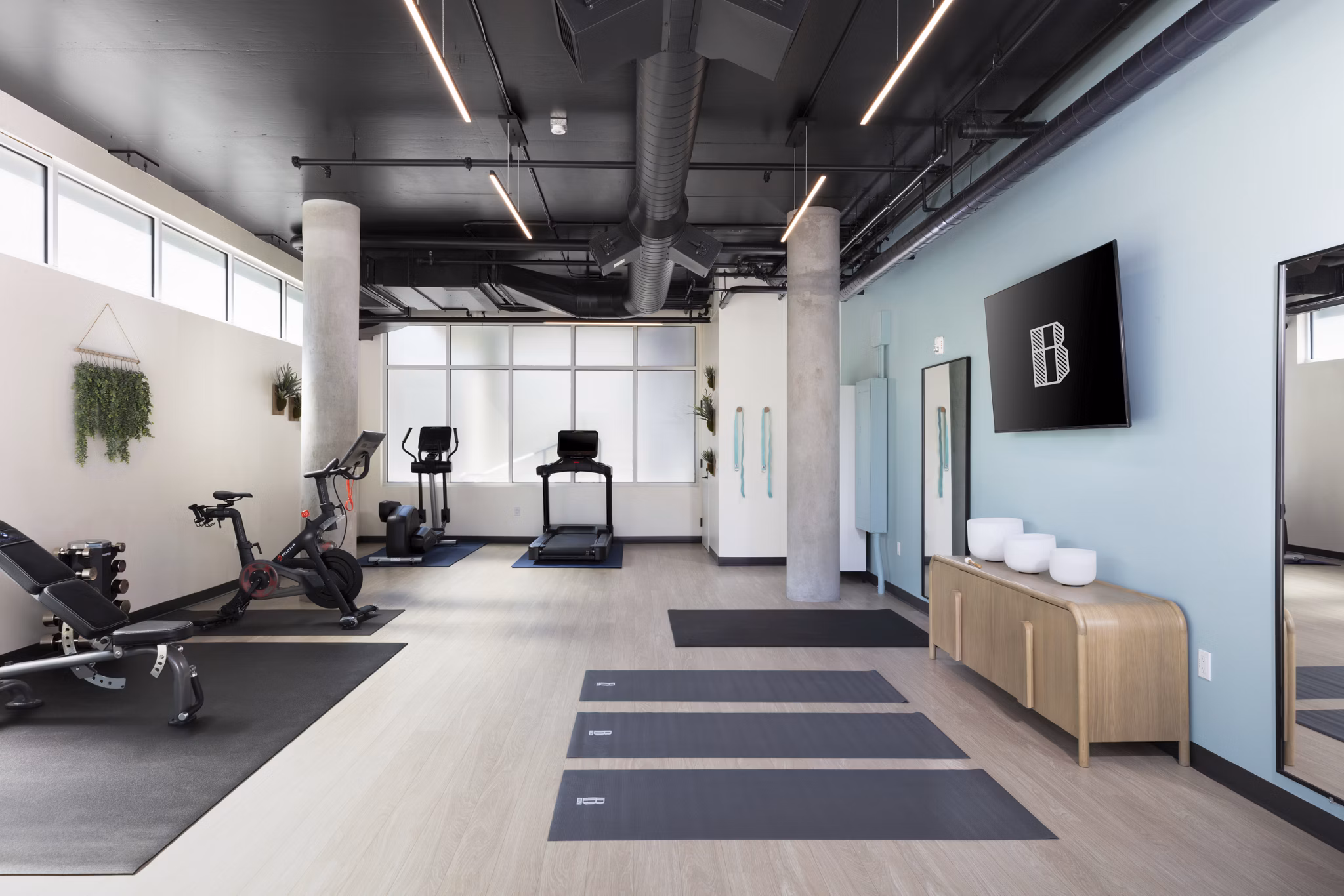 Fitness center with modern equipment at The Brady Apartments