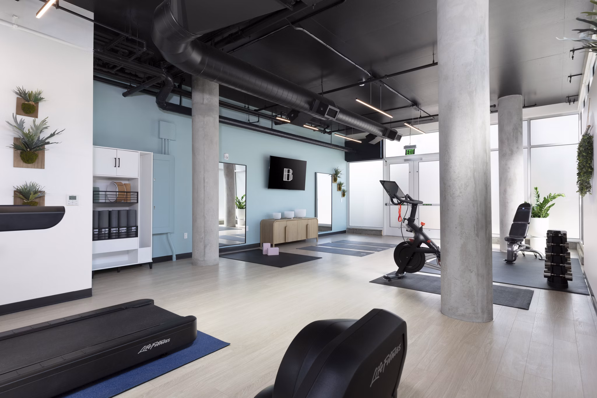 The Brady Apartment: Modern fitness center with state-of-the-art equipment and spacious workout areas