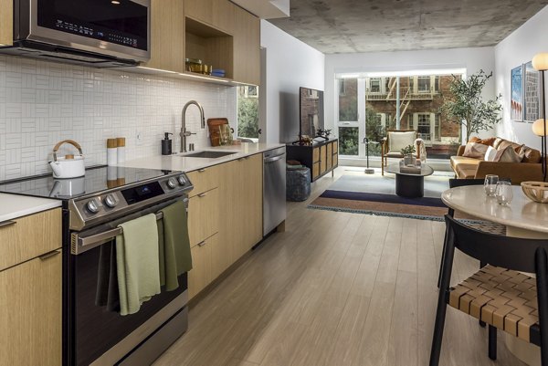 Modern kitchen with sleek cabinetry and stainless steel appliances at The Brady Apartments