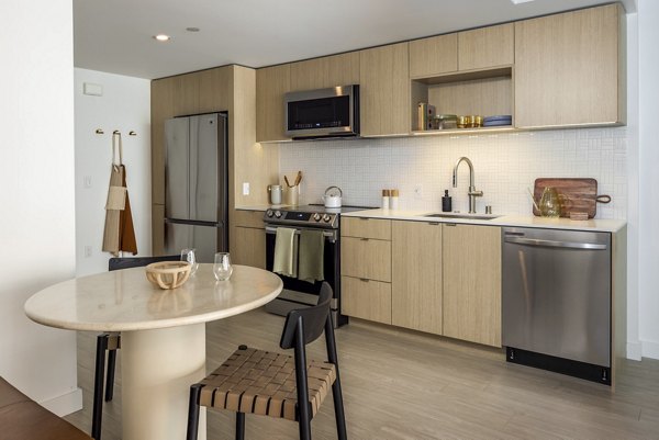 Modern kitchen with stainless steel appliances at The Brady Apartments, offering luxury living in a convenient urban location