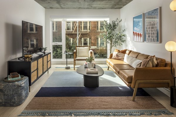 Spacious living room with stylish furnishings at The Brady Apartments in Houston, offering luxury urban living