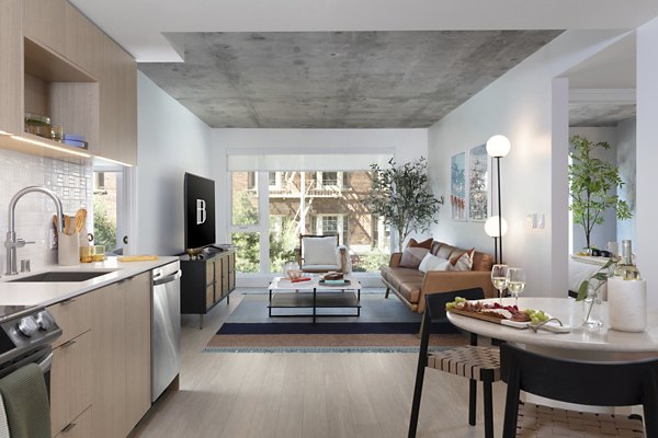 Spacious living room with modern decor, large windows, and hardwood floors at The Brady apartments