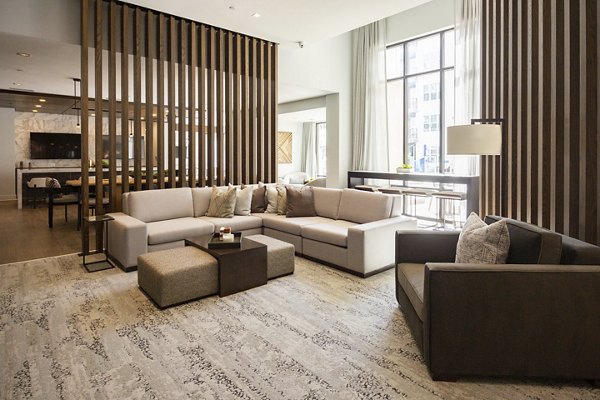 Clubhouse with modern design and cozy seating at Elden Galleria Apartments, a luxury community by Greystar