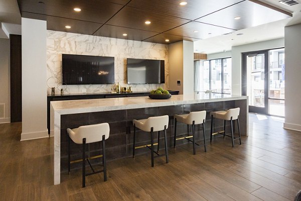 Clubhouse featuring modern decor and cozy seating at Elden Galleria Apartments, luxury community amenities for relaxation and socializing