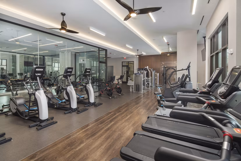 Fitness center with modern equipment at Elden Galleria Apartments offering luxury living space
