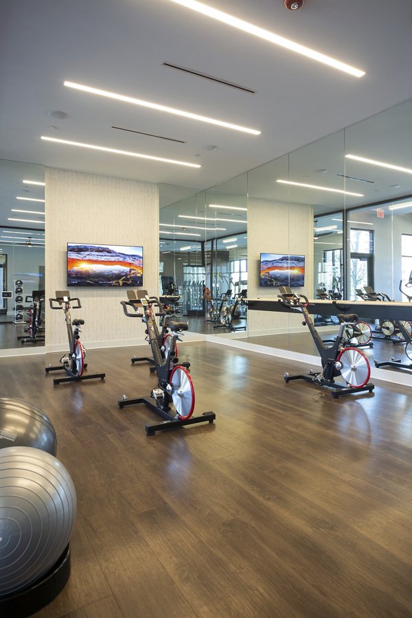 Fitness center with modern equipment at Elden Galleria Apartments offering luxury living space