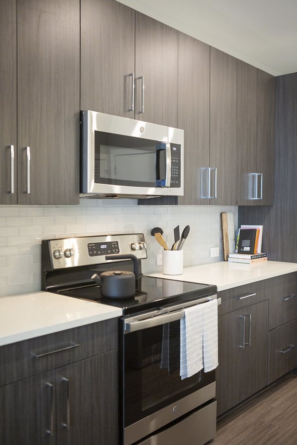 Elden Galleria Apartments: Modern kitchen with stainless steel appliances and quartz countertops