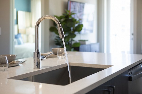 Modern kitchen with stainless steel appliances at Elden Galleria Apartments in Greystar's luxury portfolio