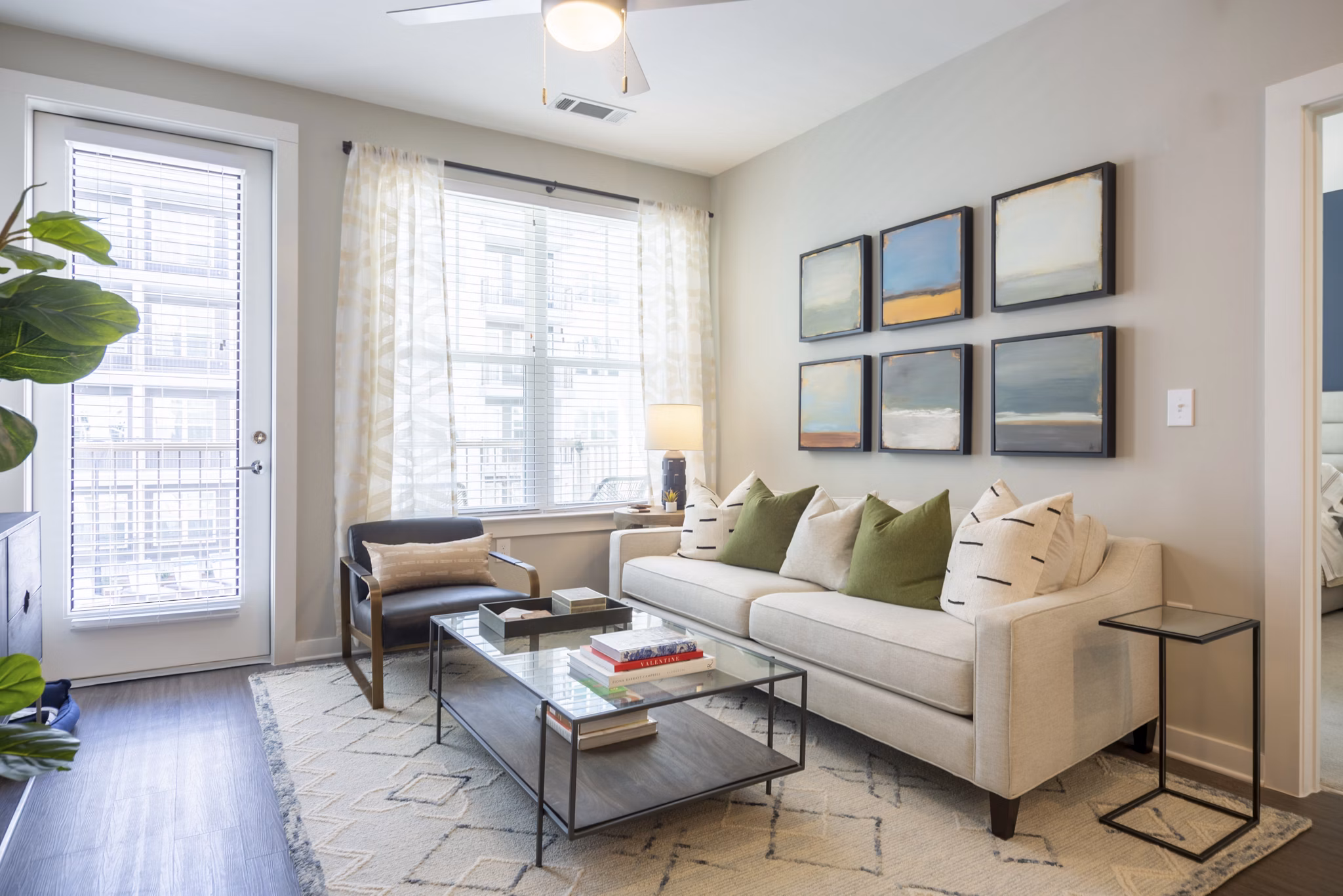 Living room featuring modern furnishings and large windows at Elden Galleria Apartments, luxury living in a vibrant community