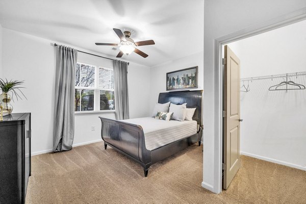 Bedroom with elegant decor including large windows in Fox Hunt Farms Apartments