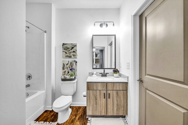 Modern bathroom featuring elegant fixtures and glass shower in Fox Hunt Farms Apartments