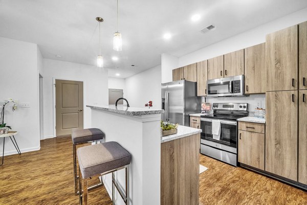 Modern kitchen with stainless steel appliances in Fox Hunt Farms Apartments