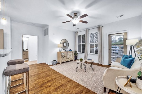 Living room featuring cozy furnishings and natural light at Fox Hunt Farms Apartments