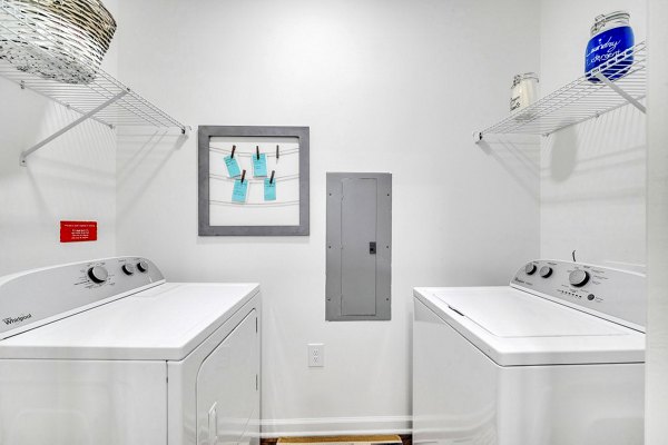 Modern laundry room with high-efficiency washers & dryers in Fox Hunt Farms Apartments