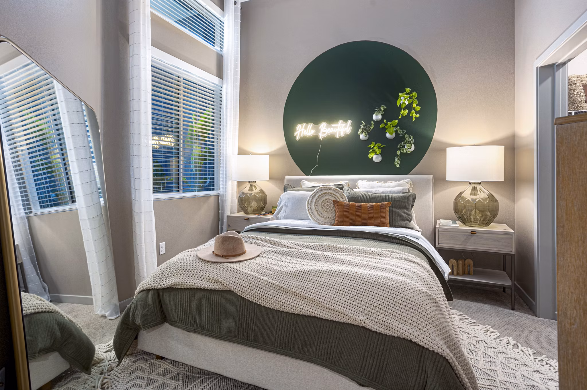 Bedroom with large windows and modern decor in Jefferson Cenza Apartments, luxury property by Greystar
