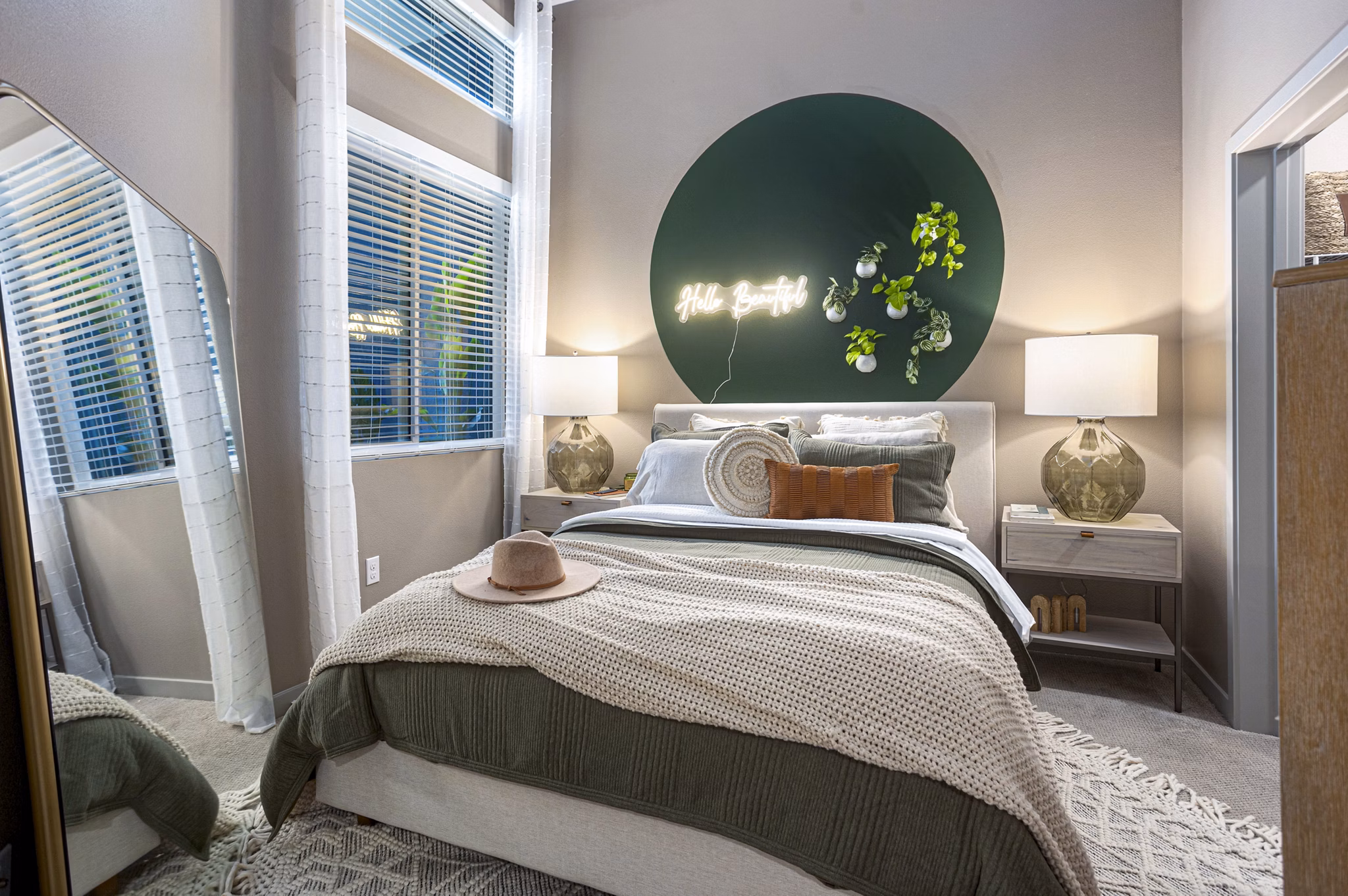Bedroom with large windows and modern decor in Jefferson Cenza Apartments, luxury property by Greystar
