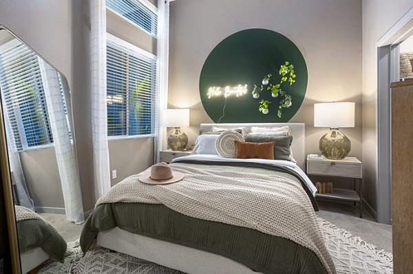 Bedroom with large windows and modern decor in Jefferson Cenza Apartments, luxury property by Greystar