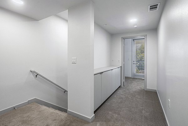 Bedroom featuring modern decor and natural light at Jefferson Cenza Apartments