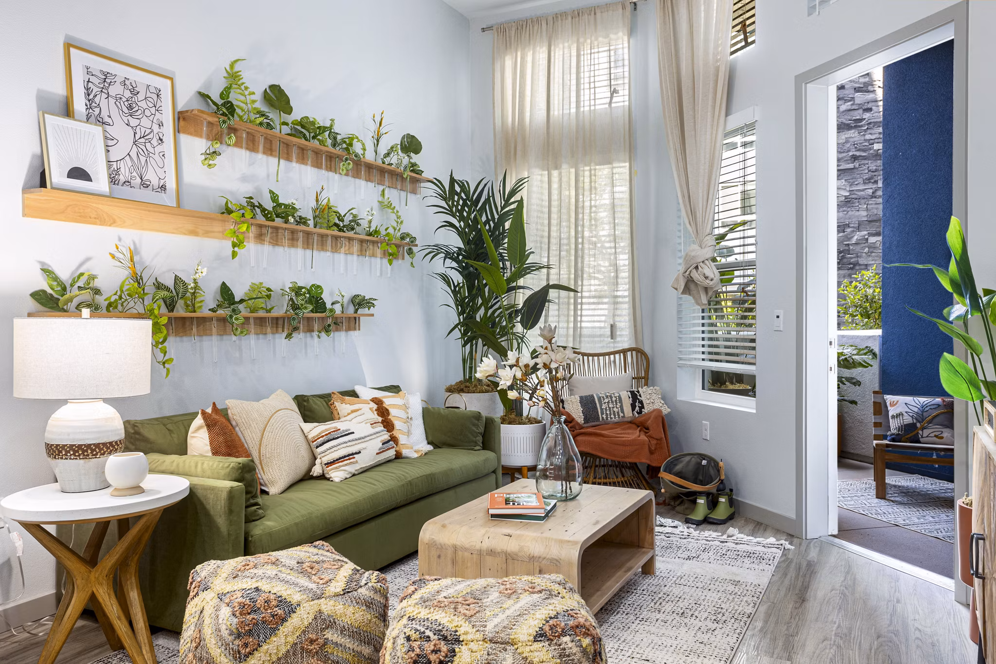 Modern living room with plush seating and large windows at Jefferson Cenza Apartments