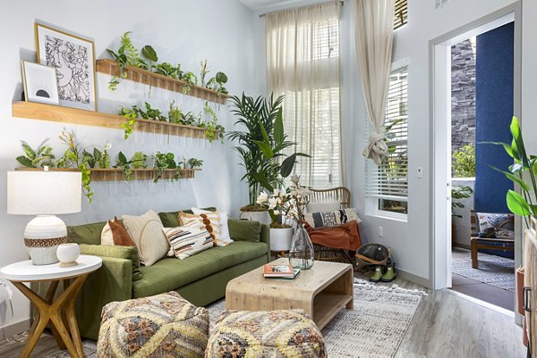 Modern living room with plush seating and large windows at Jefferson Cenza Apartments