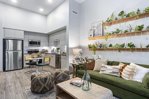 Modern living room with sleek furniture and open layout at Jefferson Cenza Apartments