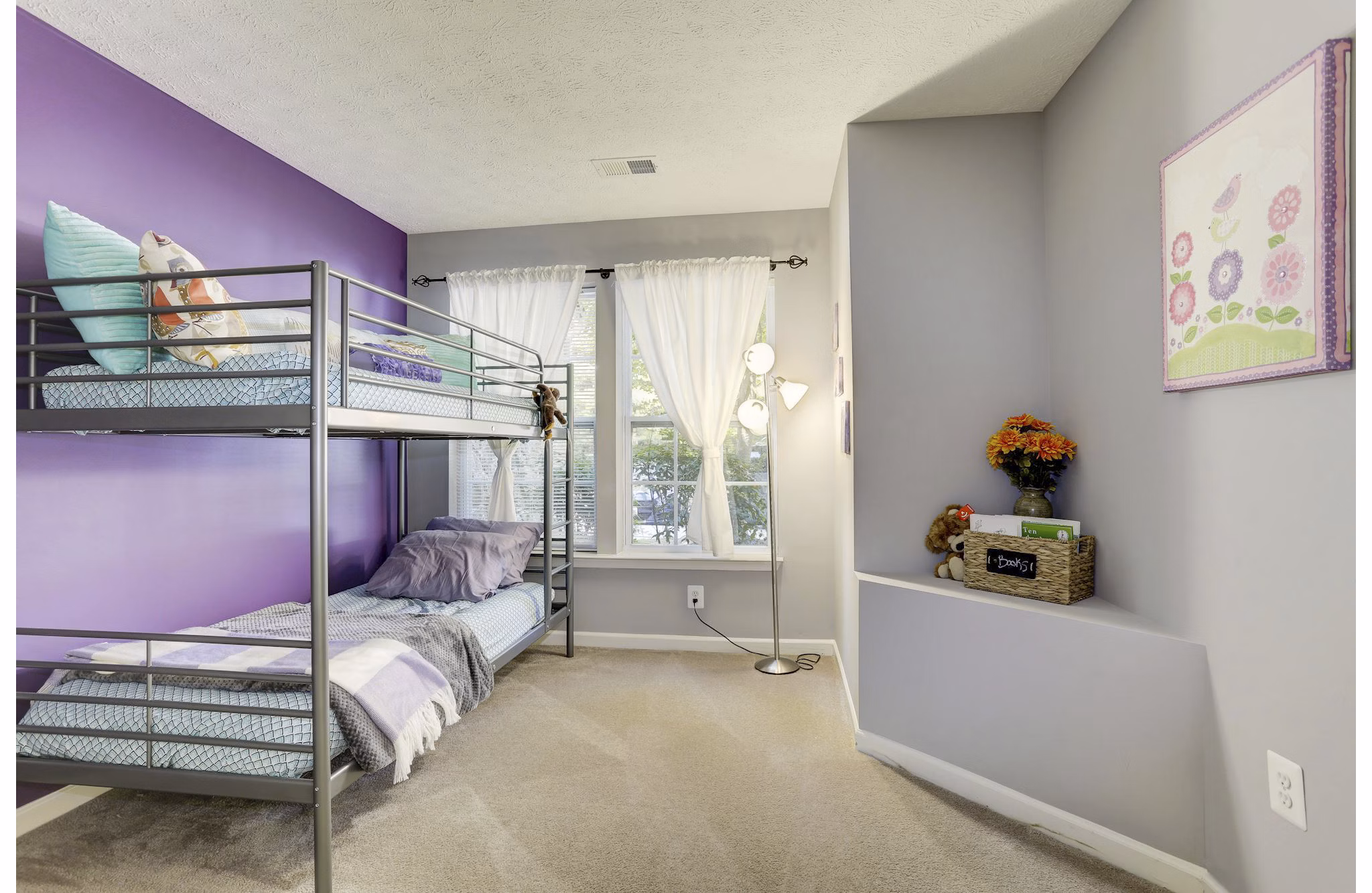 Modern bedroom featuring cozy dÃ©cor and ample natural light in Kaiser Park Apartments