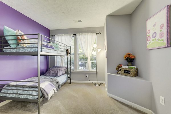 Modern bedroom featuring cozy dÃ©cor and ample natural light in Kaiser Park Apartments